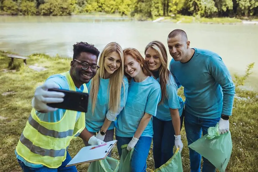 A volunteer group celebrating after a community cleanup event